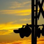 railroad crossing with sunset